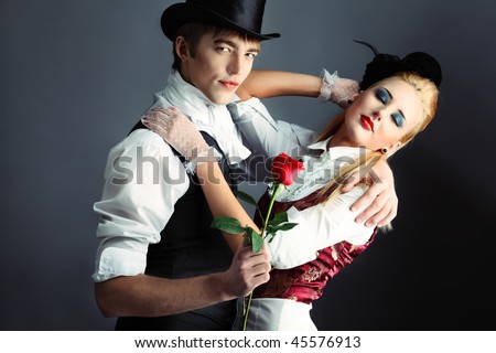 Portrait of the elegant young couple in medieval era costumes. Shot in a studio.