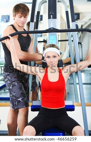 Couple of a sporty young people in the gym centre.