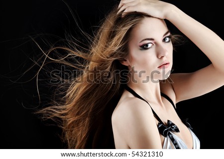 Shot of an attractive young woman with windy hair.