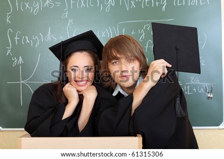 Educational theme: graduating students in academic gown in a classroom.