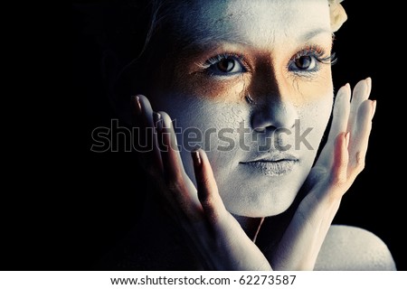 stock photo Portrait of an artistic woman painted with white and bronze 