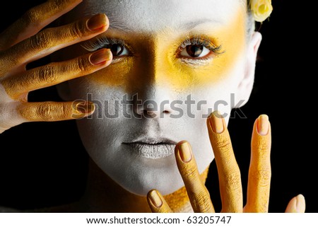 stock photo Portrait of an artistic woman painted with white and bronze 