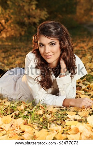 Young pretty woman at the autumn park