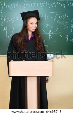 Educational theme: graduating student in academic gown in a classroom.