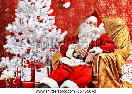 Santa Claus with presents and New Year tree at home. Christmas.