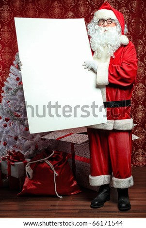 Portrait of Santa Claus holding white board. Christmas.