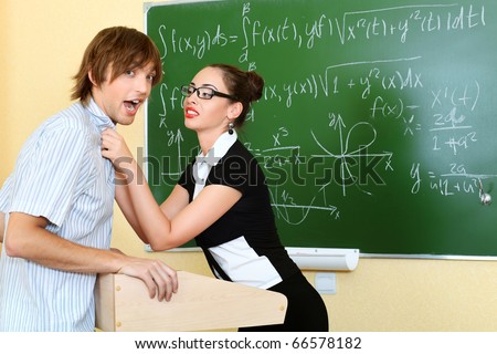 Educational theme: angry teacher with her student at a classroom.