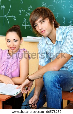 Educational theme: happy students in a classroom.