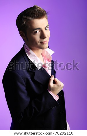 stock photo : Young man dressed in rock'n'roll style, posing over