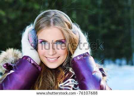 Beautiful young woman in winter clothes outdoor.