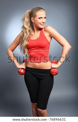 Shot of a sporty young woman with dumbbells. Active sporty life, wellness.