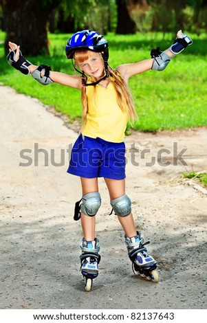 Little girl in roller skates at a park.