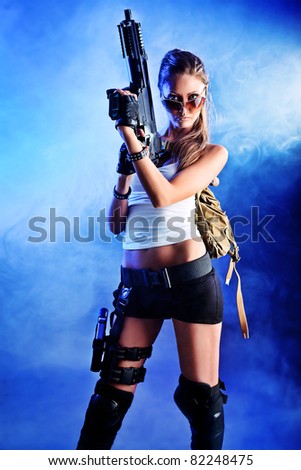 Shot of a sexy military woman posing with guns.