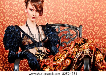 Fashion shot of a beautiful model over vintage background.