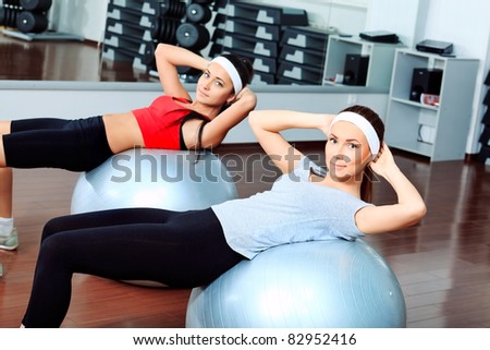 Two young sporty woman in the gym centre.