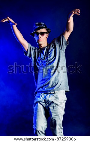 Young man dancing hip-hop at studio.