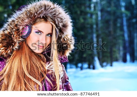 Beautiful young woman in winter clothes outdoor.