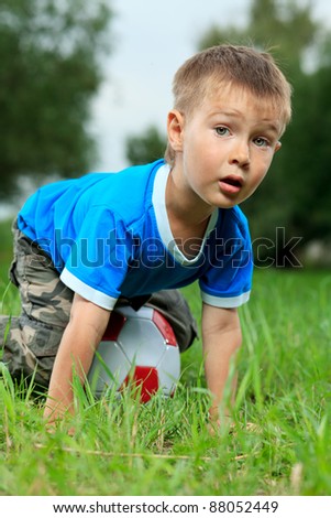 Shot of a cute emotional boy with a ball outdoor.