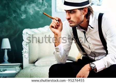 Portrait of a handsome fashionable man posing in the interior.