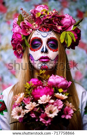 Dia de los muertos. Day of The Dead. Woman with sugar skull makeup on a floral background. Calavera Catrina. Halloween.