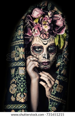 Closeup portrait of Calavera Catrina. Young woman with sugar skull makeup. Dia de los muertos. Day of The Dead. Halloween.