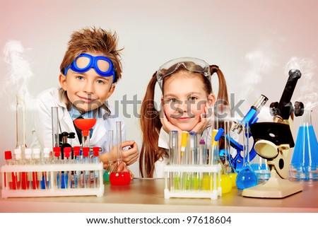 Two children making science experiments. Education.