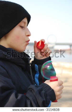 Boy makes soap bubbles