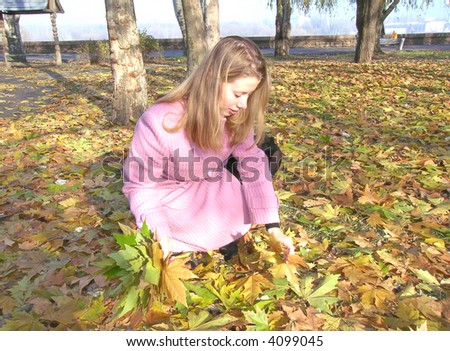 Girl picking up leaves