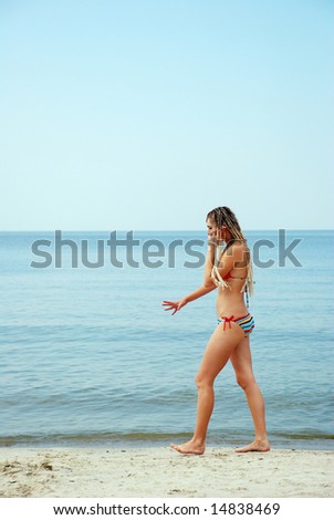 girl cell on phone on sea background