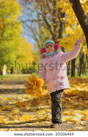 Funny happy child in autumn park