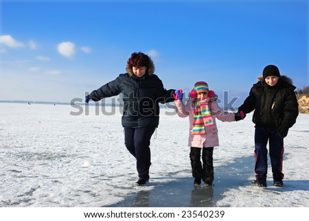 running happy family on icy river