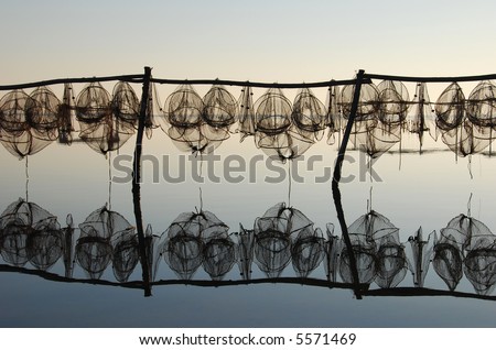 drying fish trap nets - amazing light and reflection on the calm ocean