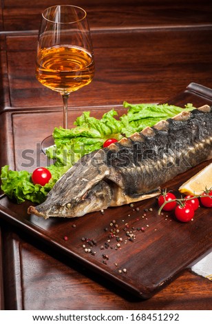 Roasted  sturgeon with cherry tomatoes and lettuce