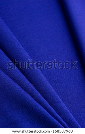 Blue cloth with straight folds texture closeup