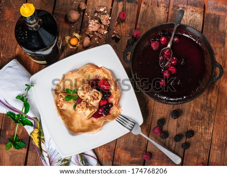 Rolled pancakes with berry jam and fresh mint