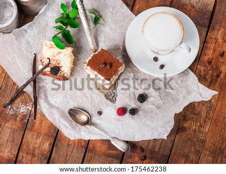 Tiramisu cake with fresh mint and cinnamon powder with coffee