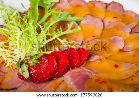 Carpaccio of duck breast with sweet sauce and strawberry