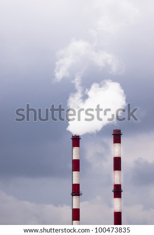 Two smoking chimneys pollution air / Smoke from the pipes of heat station