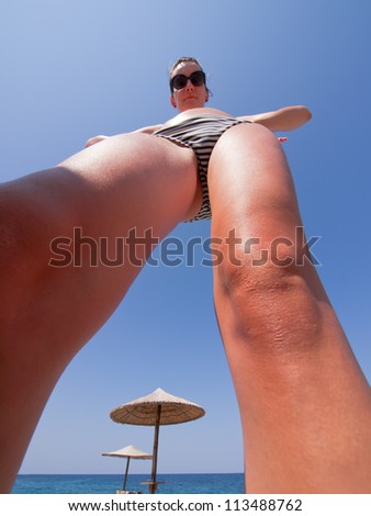 Caricature girl in swimsuit , from below with wide angle lens / great legs / funny girl