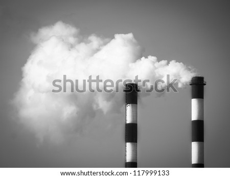 Two smoking chimneys pollution air / monochrome black and white