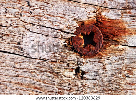 Rusty rural screw in rotten wooden table / old vintage frame