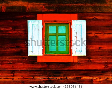 Red window in an wooden peasant house, ethnic house and window