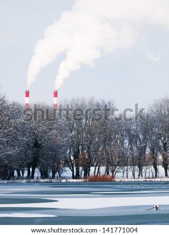 Smoking pipe chimneys near water, Belgrade Serbia, river Sava , frozen river