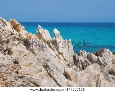 Untouched nature abstract archipelago in seashore with rocks in water on peninsula Halkidiki, Athos, Greece