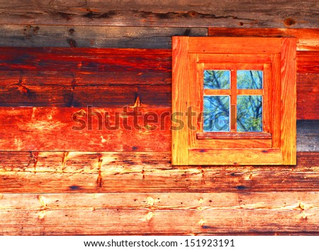 Red window in an wooden peasant house, ethnic house and window