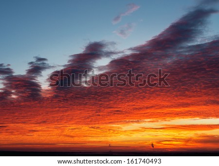 Dramatic sunset with cloud sky and smoking pipe chimneys pollution air