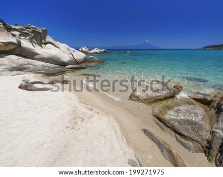 Paradise bay beach in Aegean sea, untouched nature abstract archipelago in seashore with rocks in water on peninsula Halkidiki, Greece