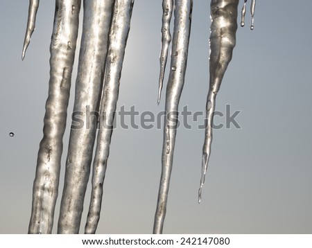 Abstract frozen thawing icicles with sun in background