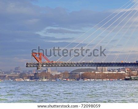 Construction of biggest bridge with one tower in the world /  river Sava   Belgrade Serbia / part of the bridge in the middle of the river /