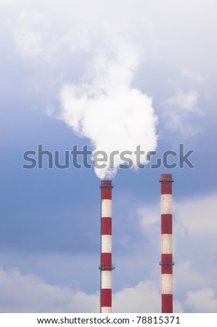 Two smoking chimneys. Toxic substances, toxic fumes.